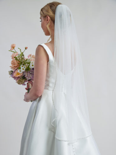 wedding veil with beaded edge being worn with lace-less wedding dress